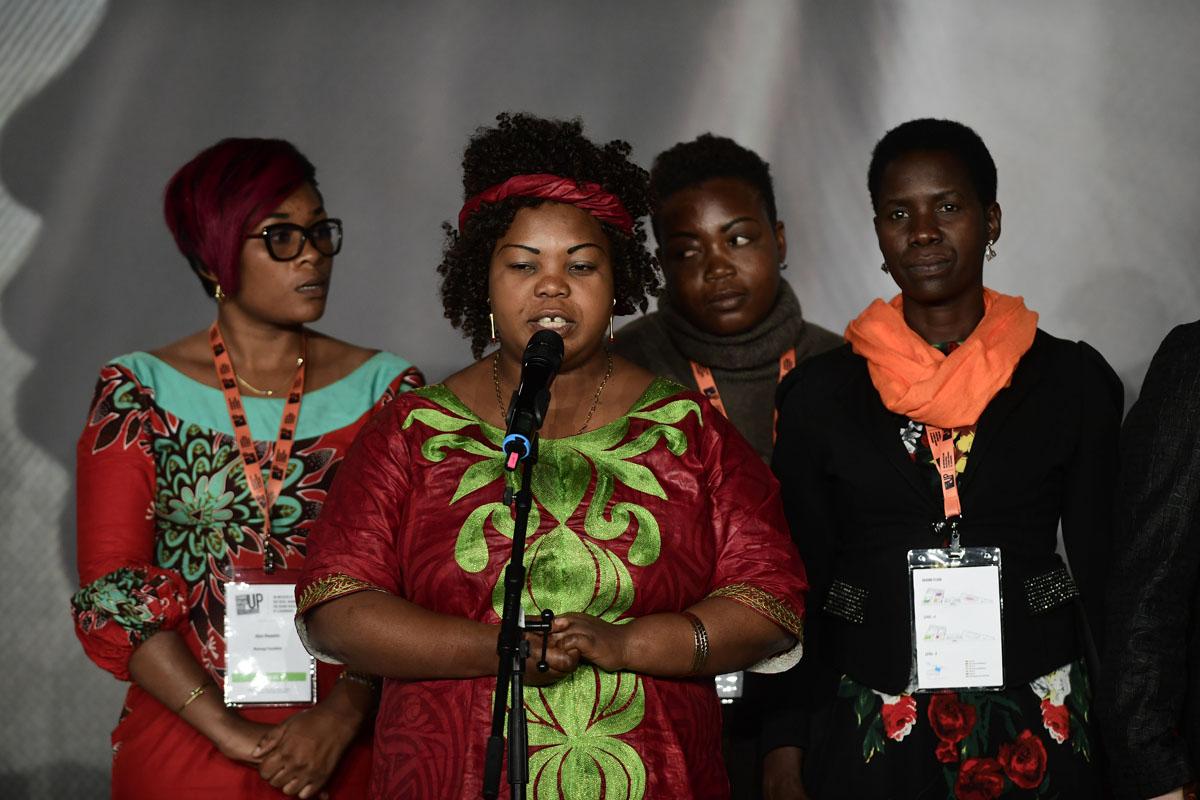 Survivors on stage at the International Forum "Stand Speak Rise Up!