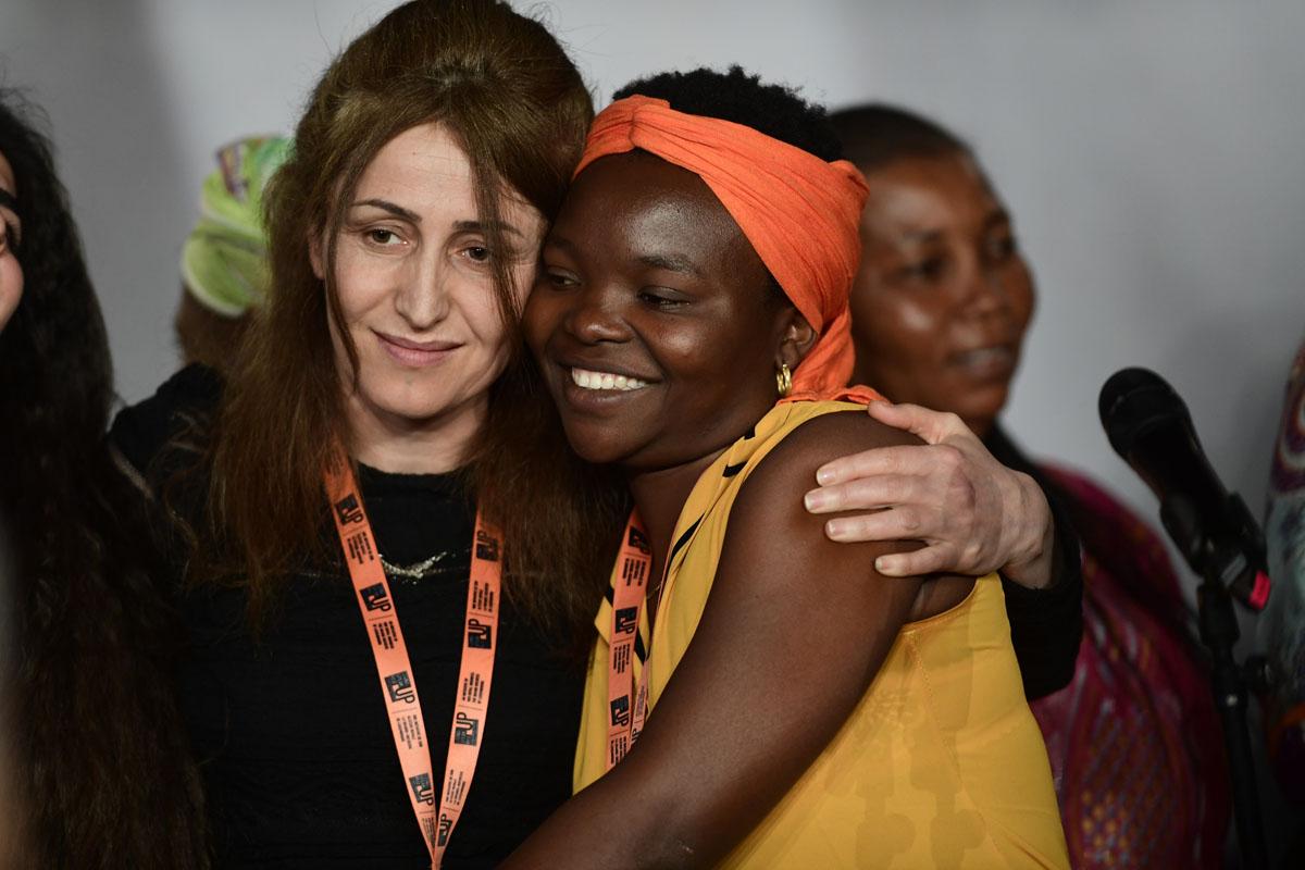 Survivors on stage at the International Forum "Stand Speak Rise Up!