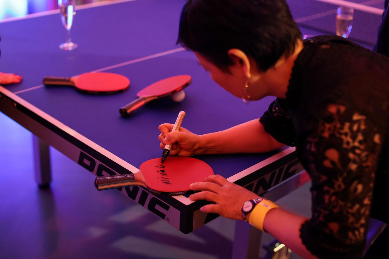 Ni Xia Lian signe une raquette de tennis de table