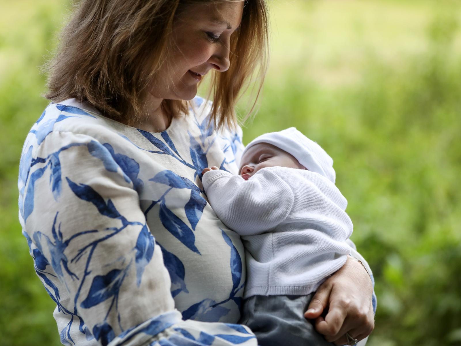 Princess Stephanie holding Prince Charles in her arms