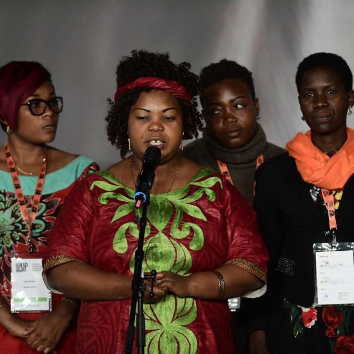 Survivors on stage at the International Forum "Stand Speak Rise Up!