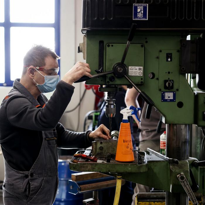 Un jeune travaille sur une machine