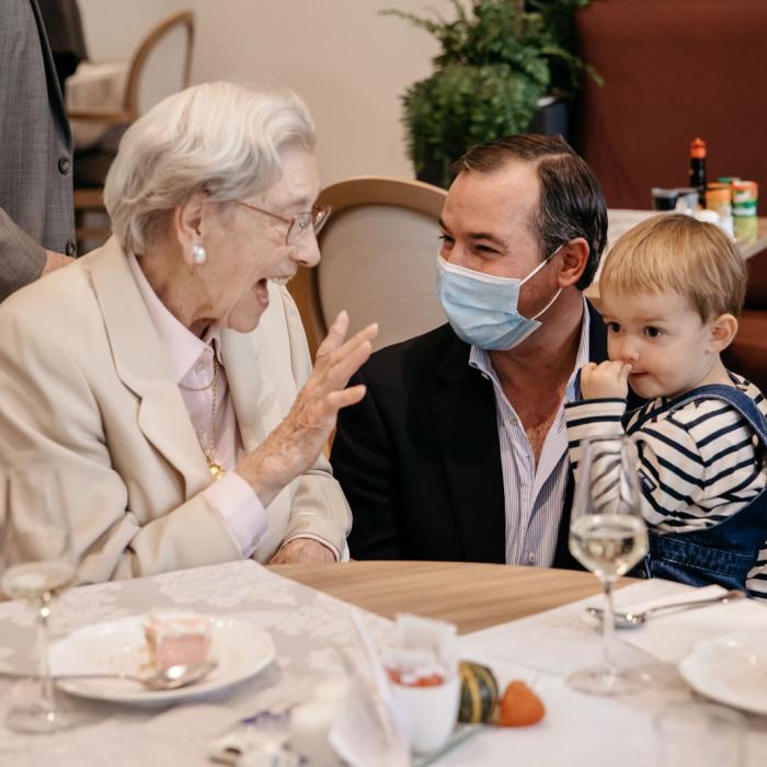 Le Prince Guillaume, avec son fils dans les bras, discute avec une résidente 