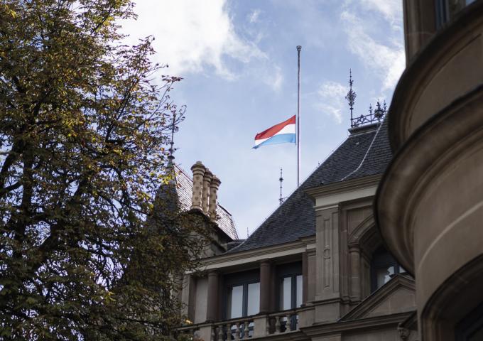 The luxembourgish flag flying at half-mast