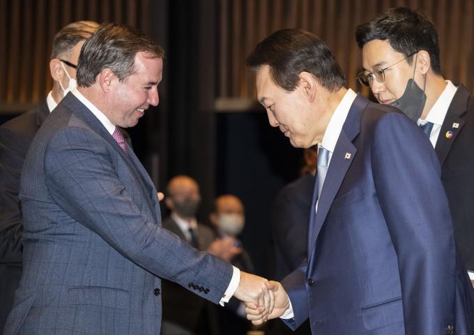 The Prince and the President of South Korea are shaking hands